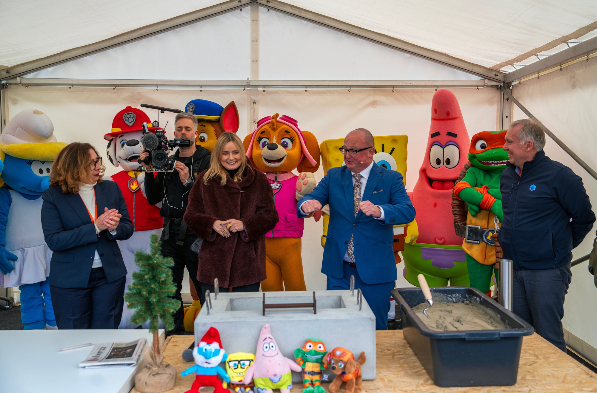 ludzie i maskotki podczas wmurowania kamienia węgielnego